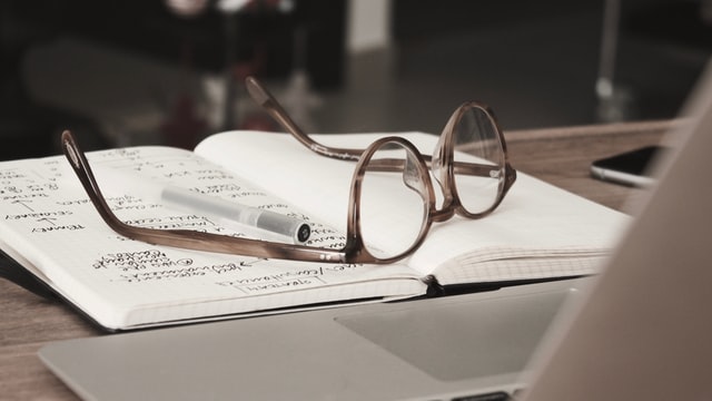 Glasses over notebook while studying